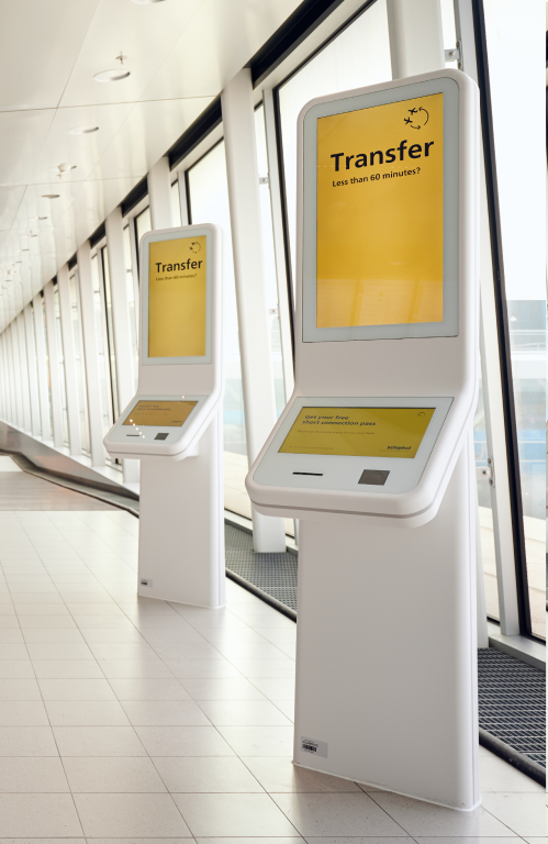 Two self service kiosk focused on transfer passengers trying to reach their next flight in time